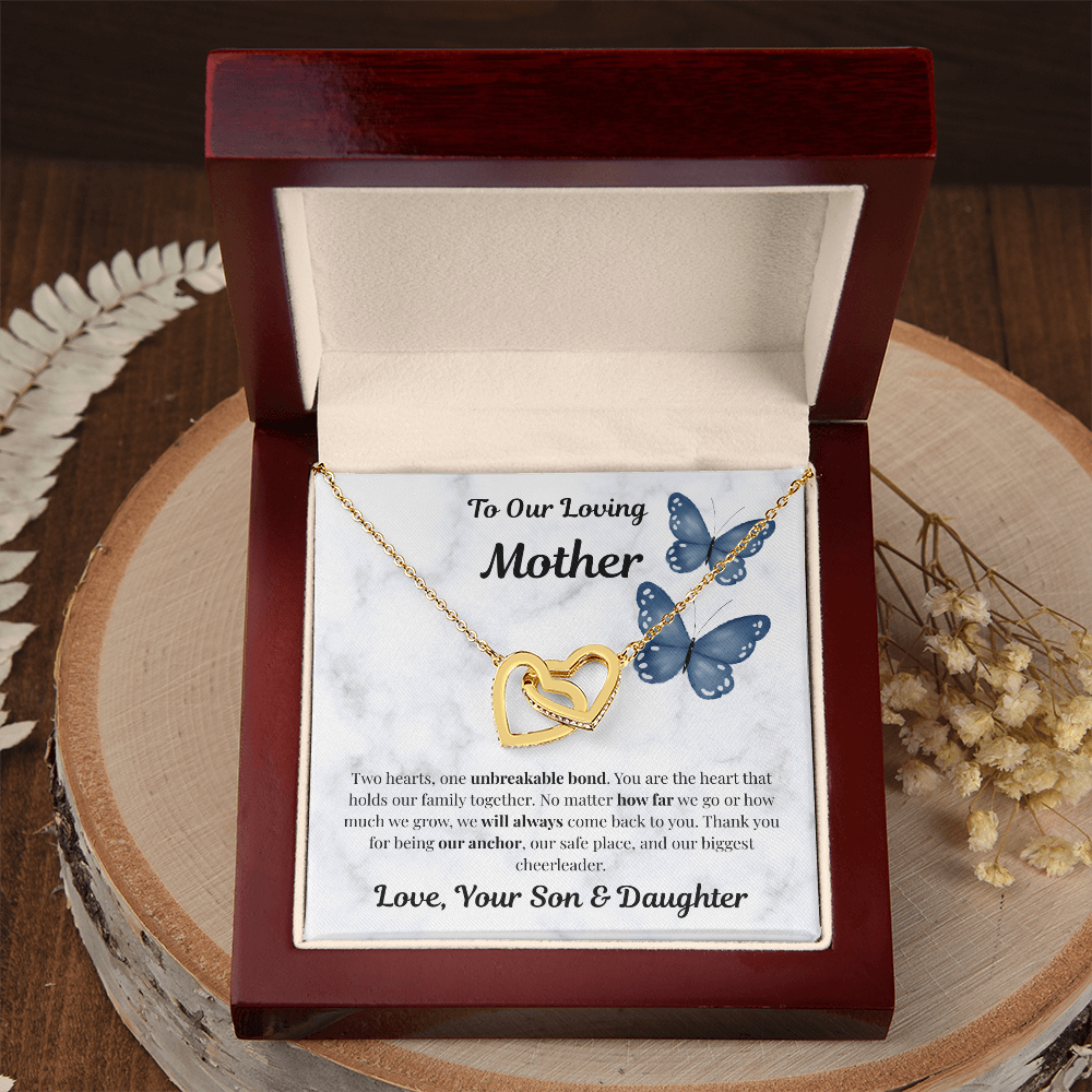 18K yellow gold-finish Interlocking Hearts Necklace in mahogany gift box on wooden tray