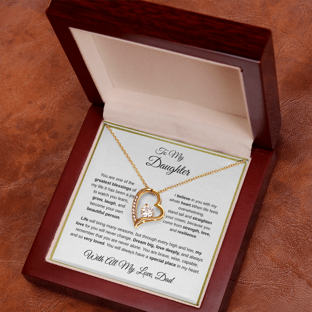 18k yellow gold-finish Forever Love Necklace in angled mahogany gift box on wooden table