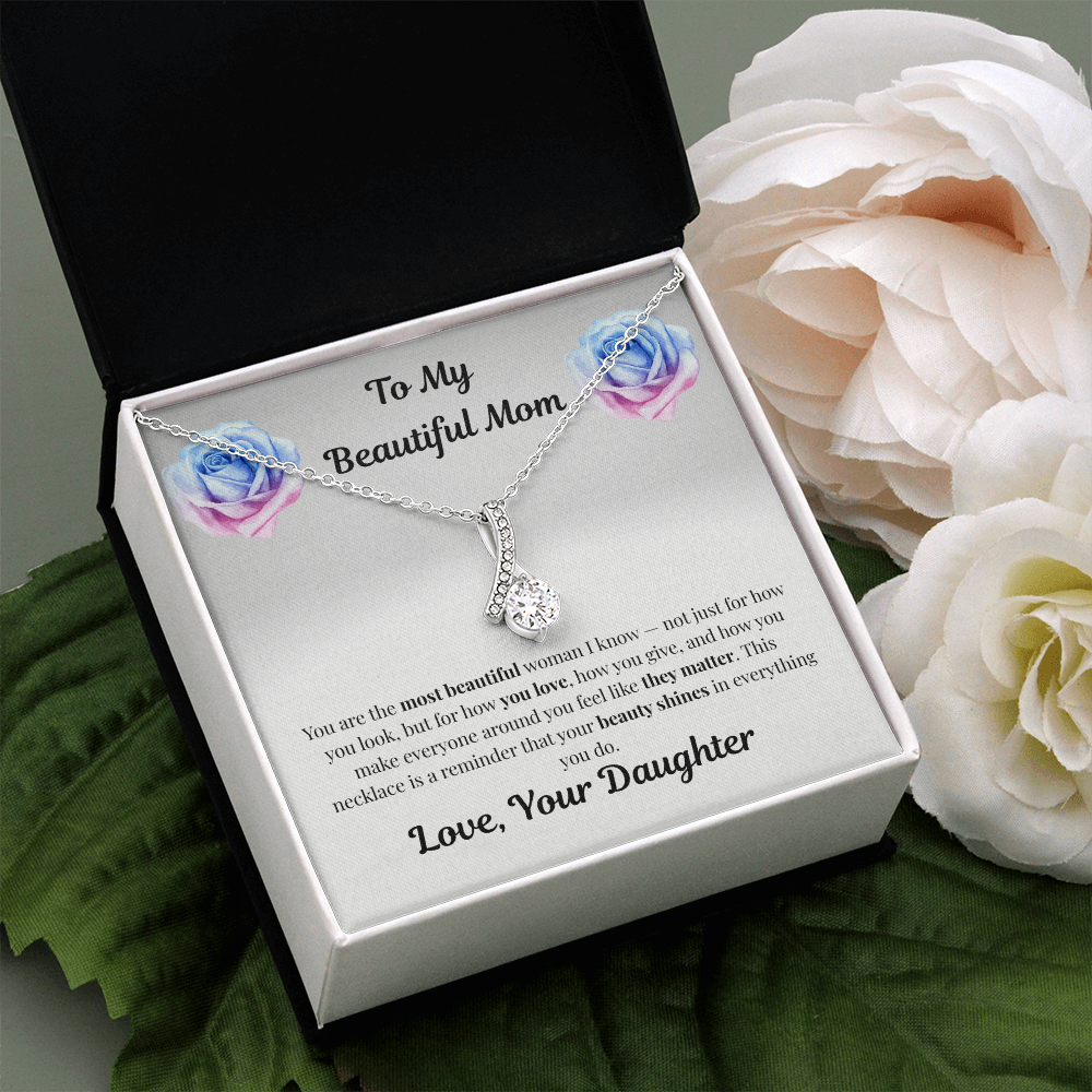 14k white gold-finish Alluring Beauty Necklace in standard gift box beside white flower