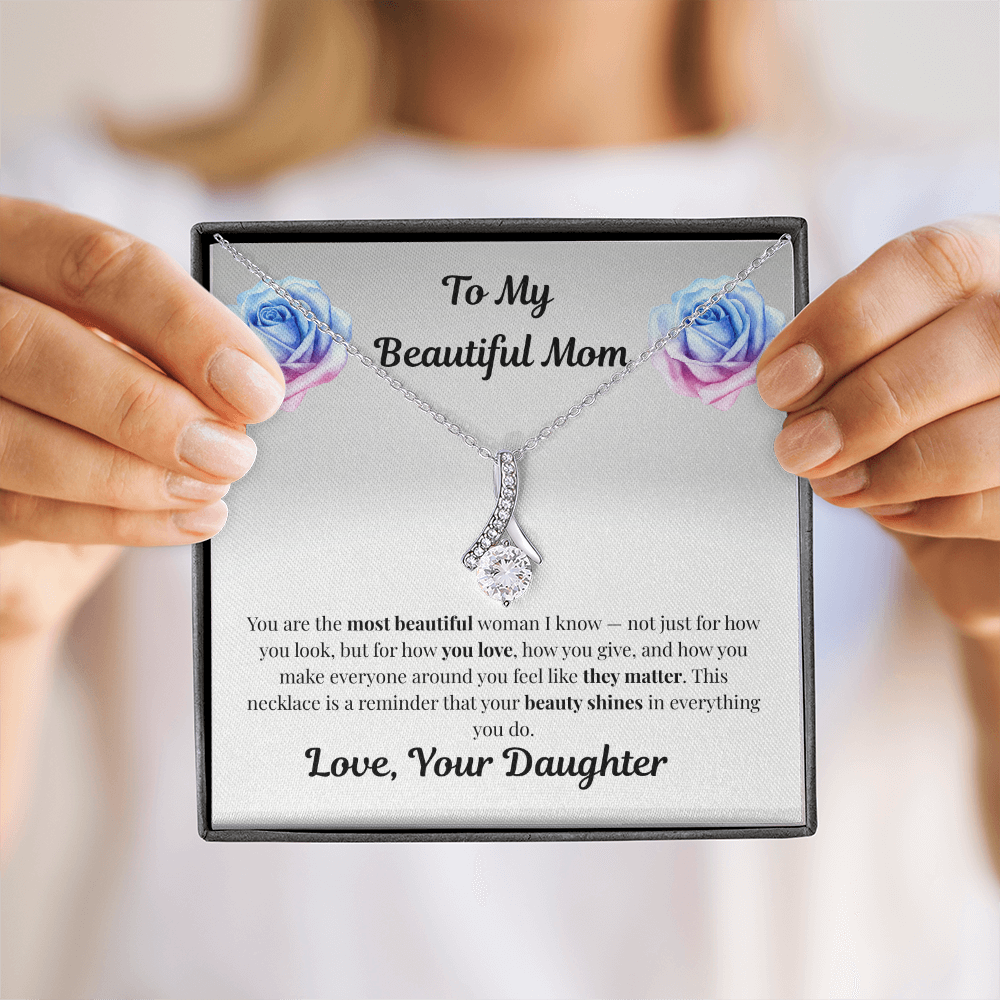 Hands holding 14k white gold-finish Alluring Beauty Necklace in standard gift box