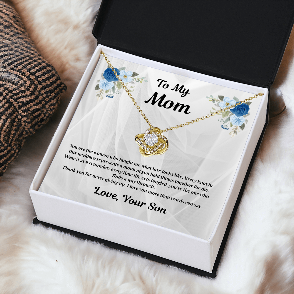 18K yellow gold-finish Love Knot Necklace in standard gift box on white fabric