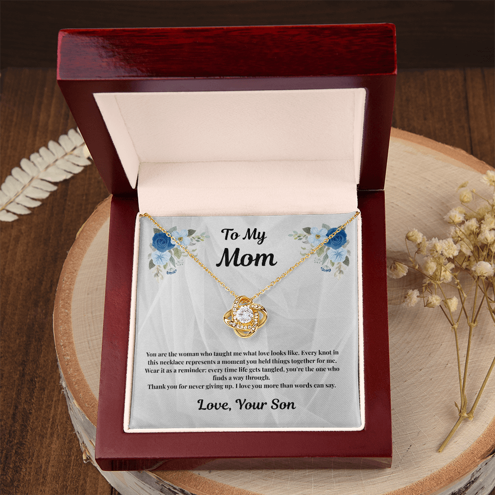 18K yellow gold-finish Love Knot Necklace in mahogany gift box on wooden tray
