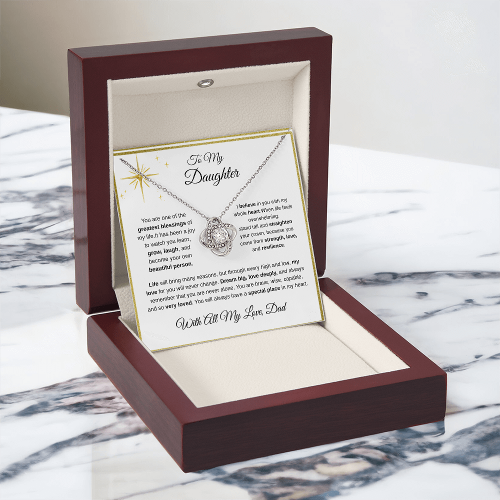 14K white gold-finish Love Knot Necklace in illuminated mahogany gift box on marble