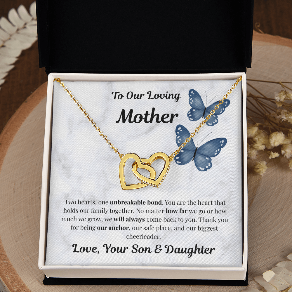18K yellow gold-finish Interlocking Hearts Necklace in standard gift box on wooden tray