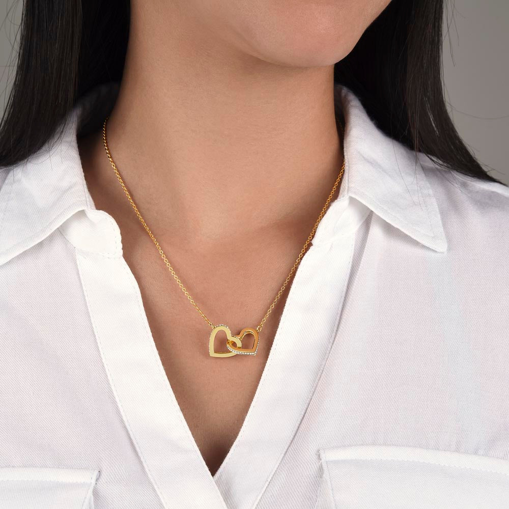 Woman wearing 18k yellow gold-finish Interlocking Hearts Necklace