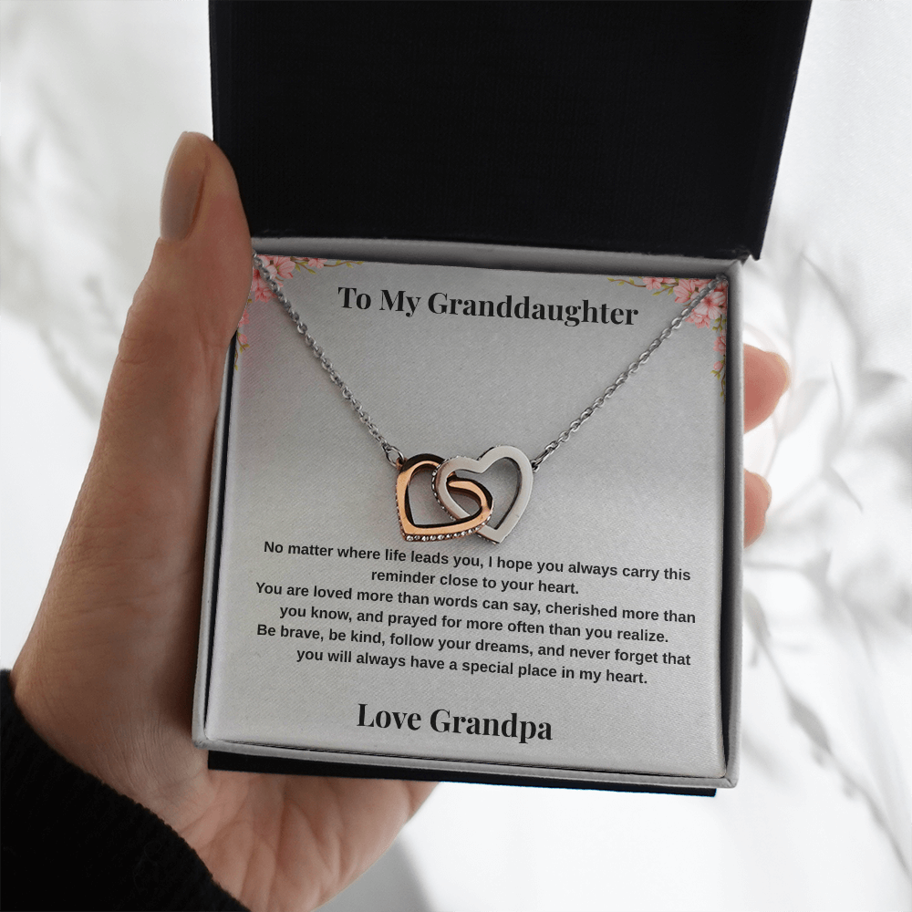 Hand holding 14k white gold-finish Interlocking Hearts Necklace in standard gift box with To My Granddaughter message card from Grandpa