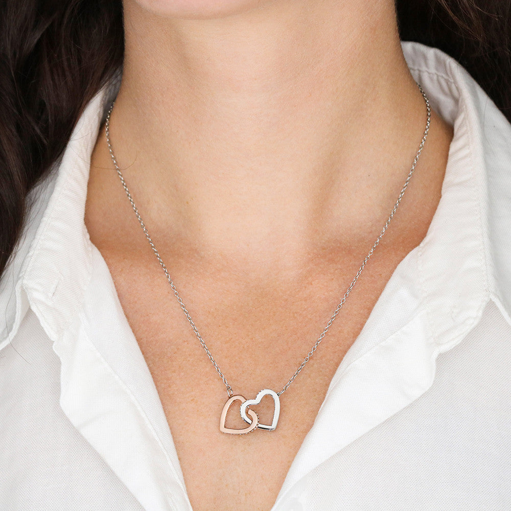 Woman wearing 14k white gold-finish Interlocking Hearts Necklace
