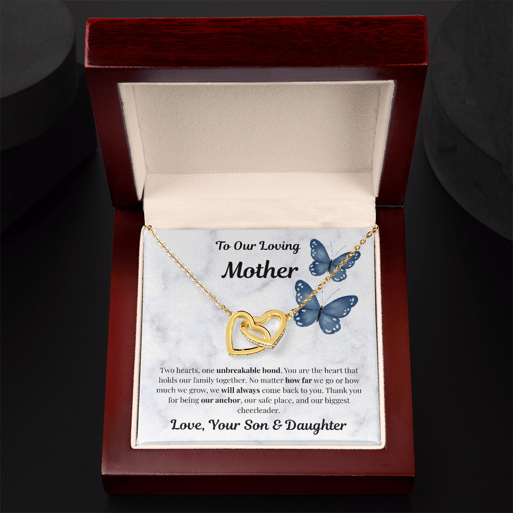 18K yellow gold-finish Interlocking Hearts Necklace in mahogany gift box on dark background