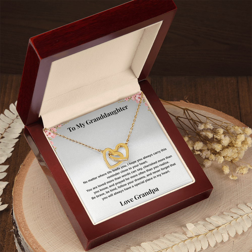 14k white gold-finish Interlocking Hearts Necklace in mahogany-style luxury gift box displayed on rustic wood table