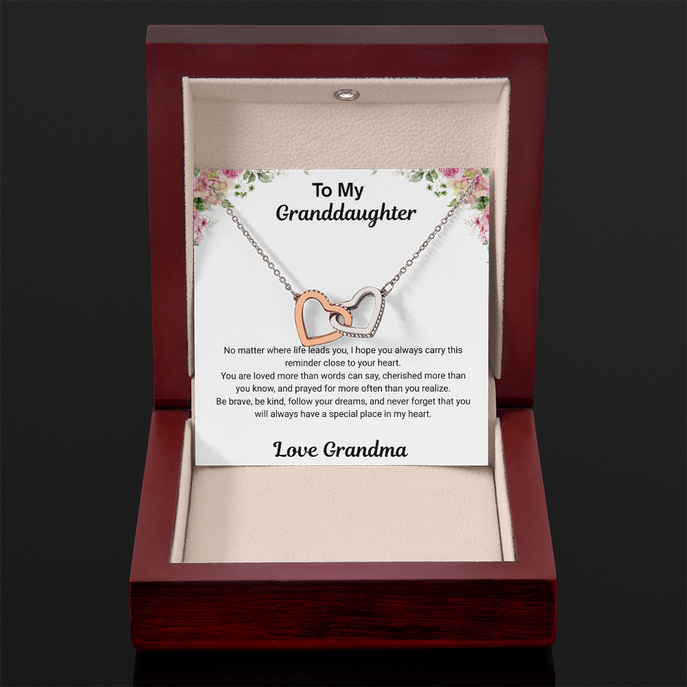 14k white gold-finish Interlocking Hearts Necklace in open mahogany-style luxury box with To My Granddaughter message card from Grandma on dark background