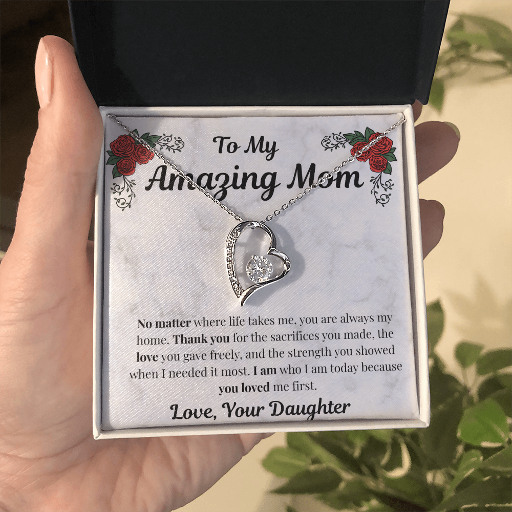 Hand holding 14k white gold-finish Forever Love Necklace in standard gift box
