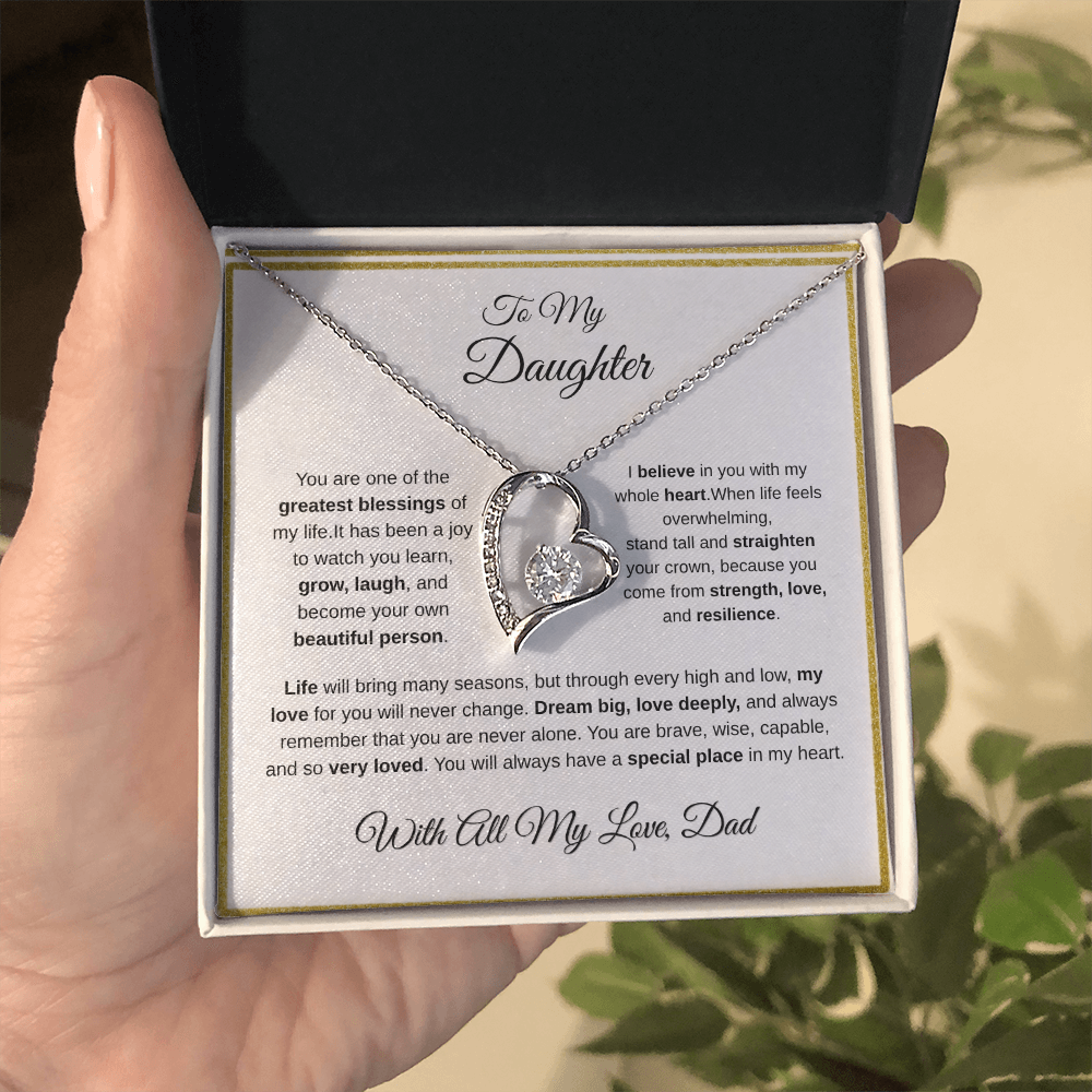 Hand holding 14k white gold-finish Forever Love Necklace in standard gift box