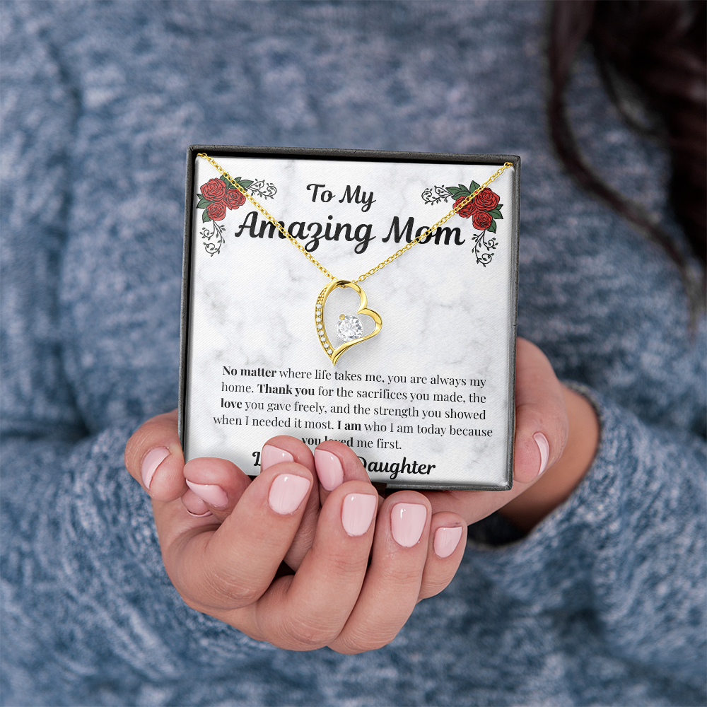 Hands holding 18k yellow gold-finish Forever Love Necklace and Mom message card
